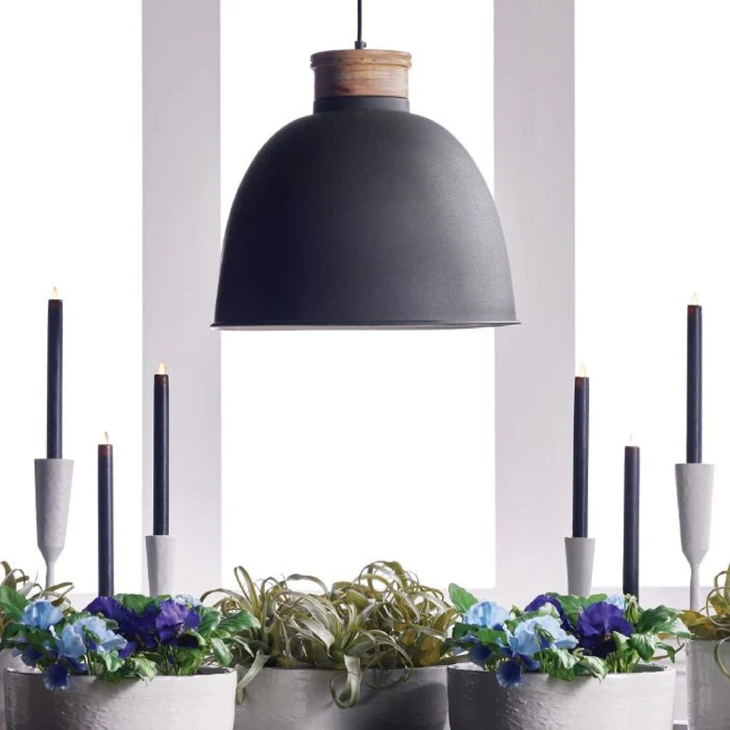 black dome pendant light over table with black candlesticks