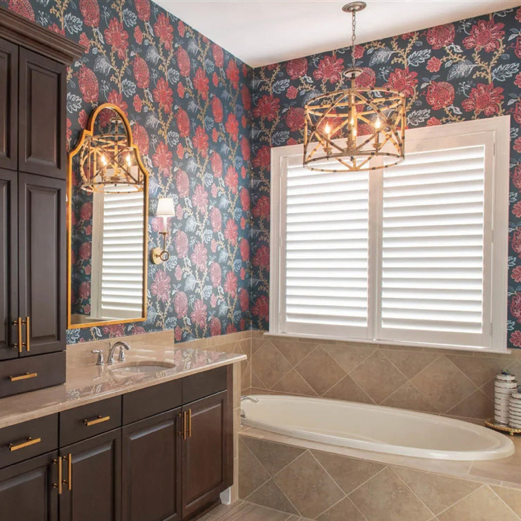 red floral wallpaper in traditional bathroom with gold bamboo light fixture