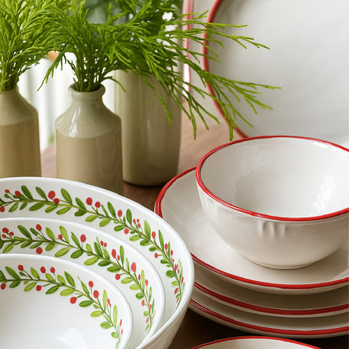Set of holiday melamine dinnerware in white with a circular holiday pattern