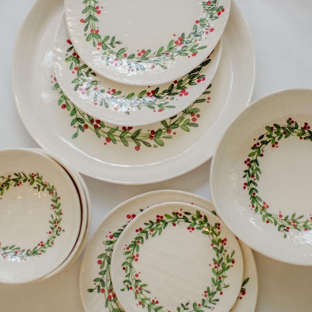 Set of ceramic plates with decorative wreath patterns on a white background