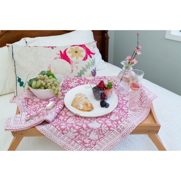 Breakfast tray with food on a bed