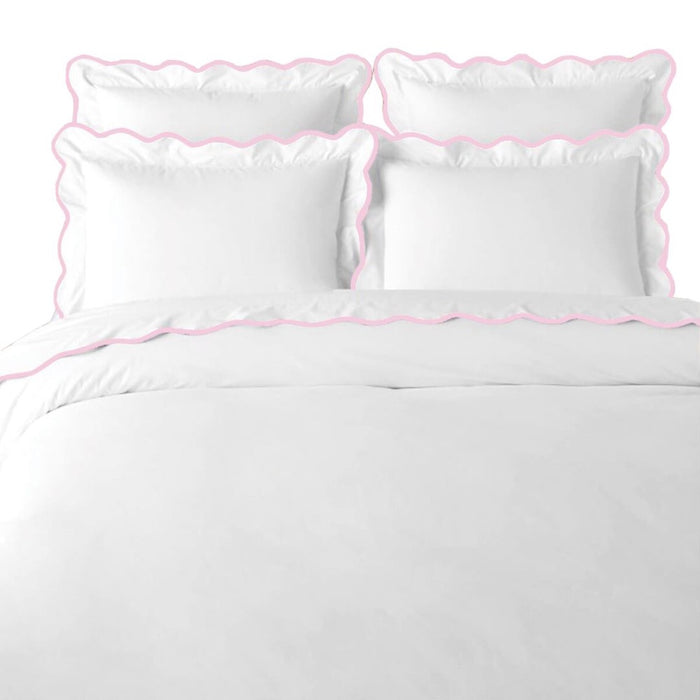 The Scalloped Pink + White Duvet Cover by Laura Park Designs adds a charming touch to any girl's room.