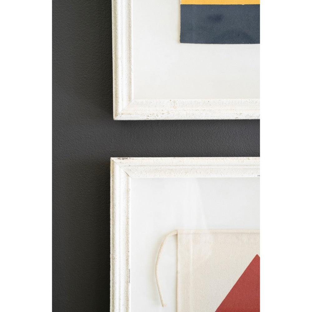 Close-up of Kalalou's Framed Nautical Canvas Flags (set of 4) adding charm to a dark wall.