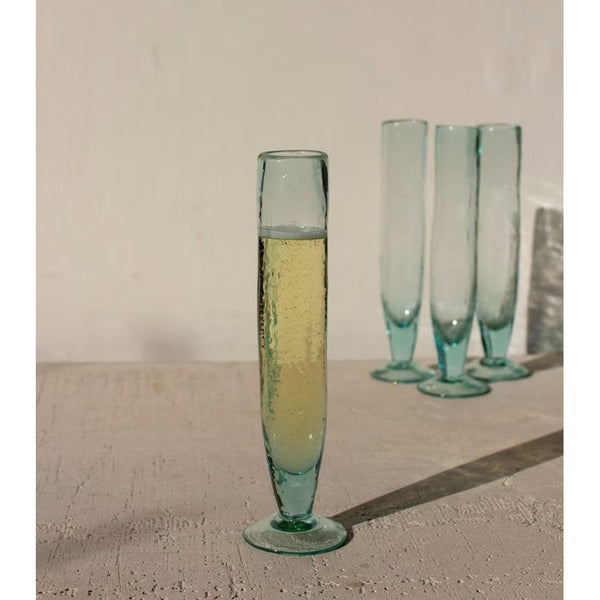 Green glass with a drink on a textured surface