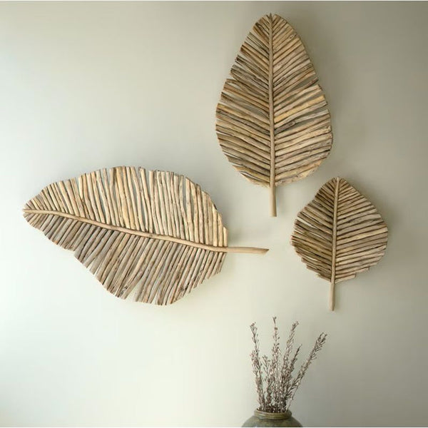 Kalalou’s Teakwood Leaves Wall Art (set of 3) brings natural charm to your decor with handcrafted wooden accents.