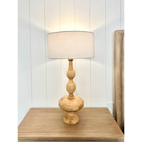 wood carved table lamp with shade on nightstand