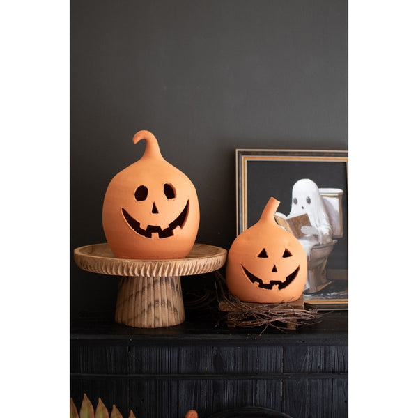 Two Kalalou Terracotta Jack-O-Lanterns (set of 2) displayed with a framed ghost picture in the background.