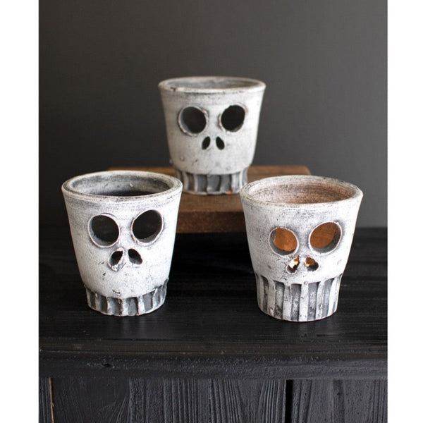 Kalalou Clay Halloween Skull Votive Holders (set of 3) are perfect spooky decor with hollow eyes and nose holes.