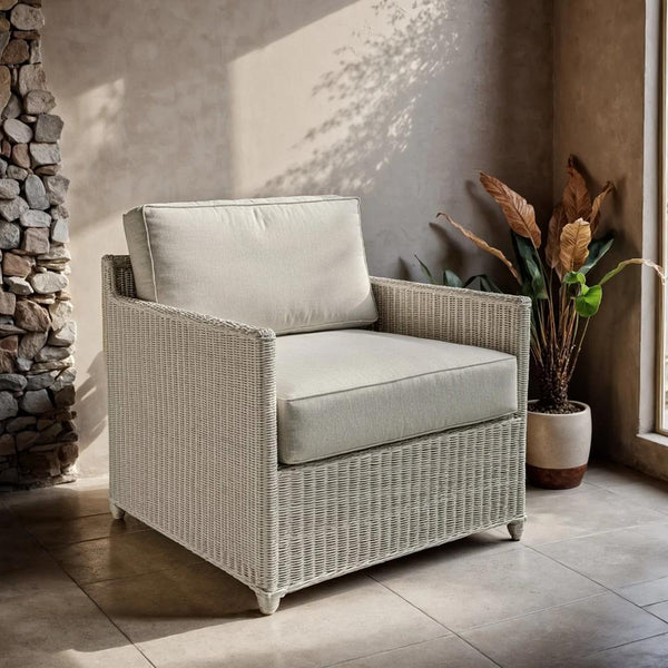 whitewashed rattan lounge chair with cushions