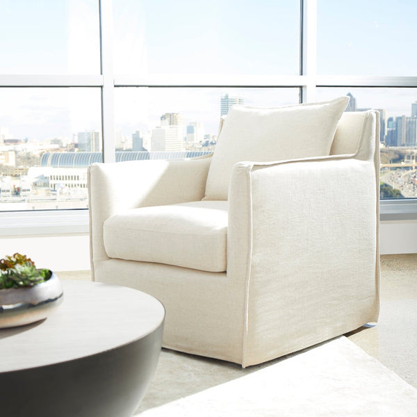 cream slipcovered swivel arm chair