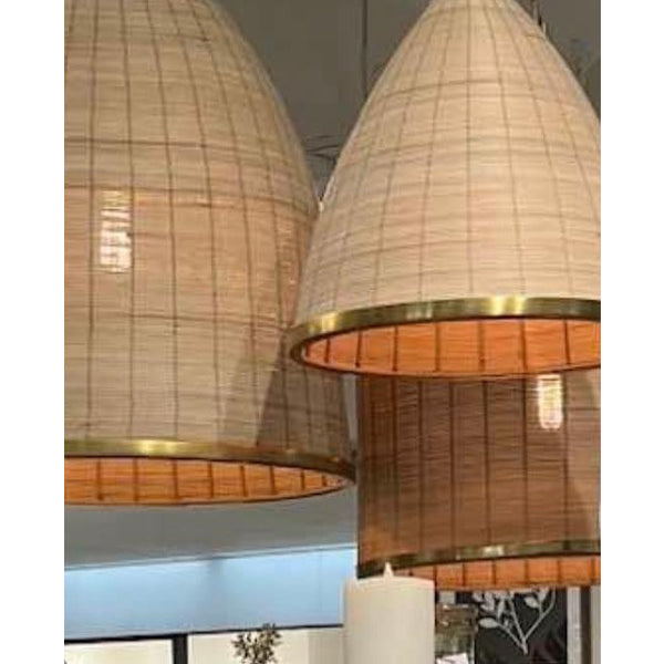 Three Maye Bell Natural Rattan Pendants by Napa Home & Garden with gold brass accents hang from the indoor ceiling.