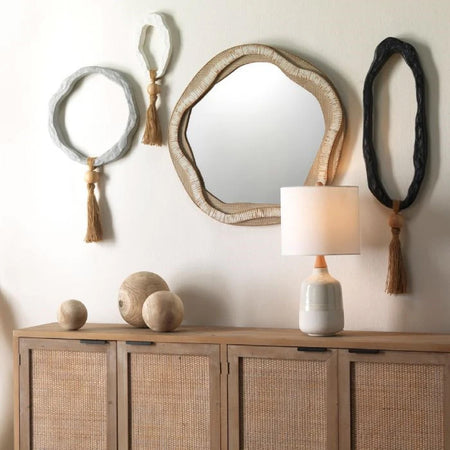 round curved wall mirror over wood console 