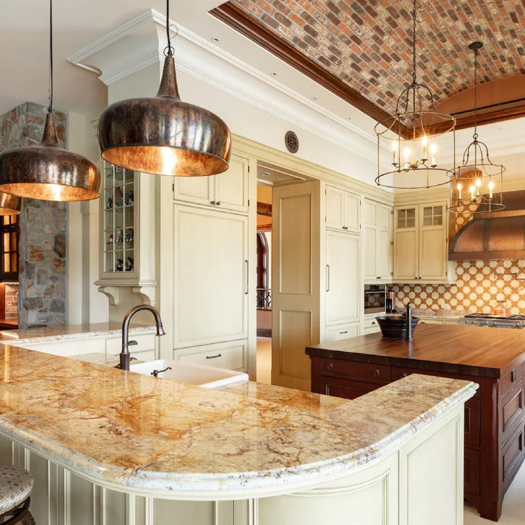Warm metal pendant lights in a traditional style kitchen
