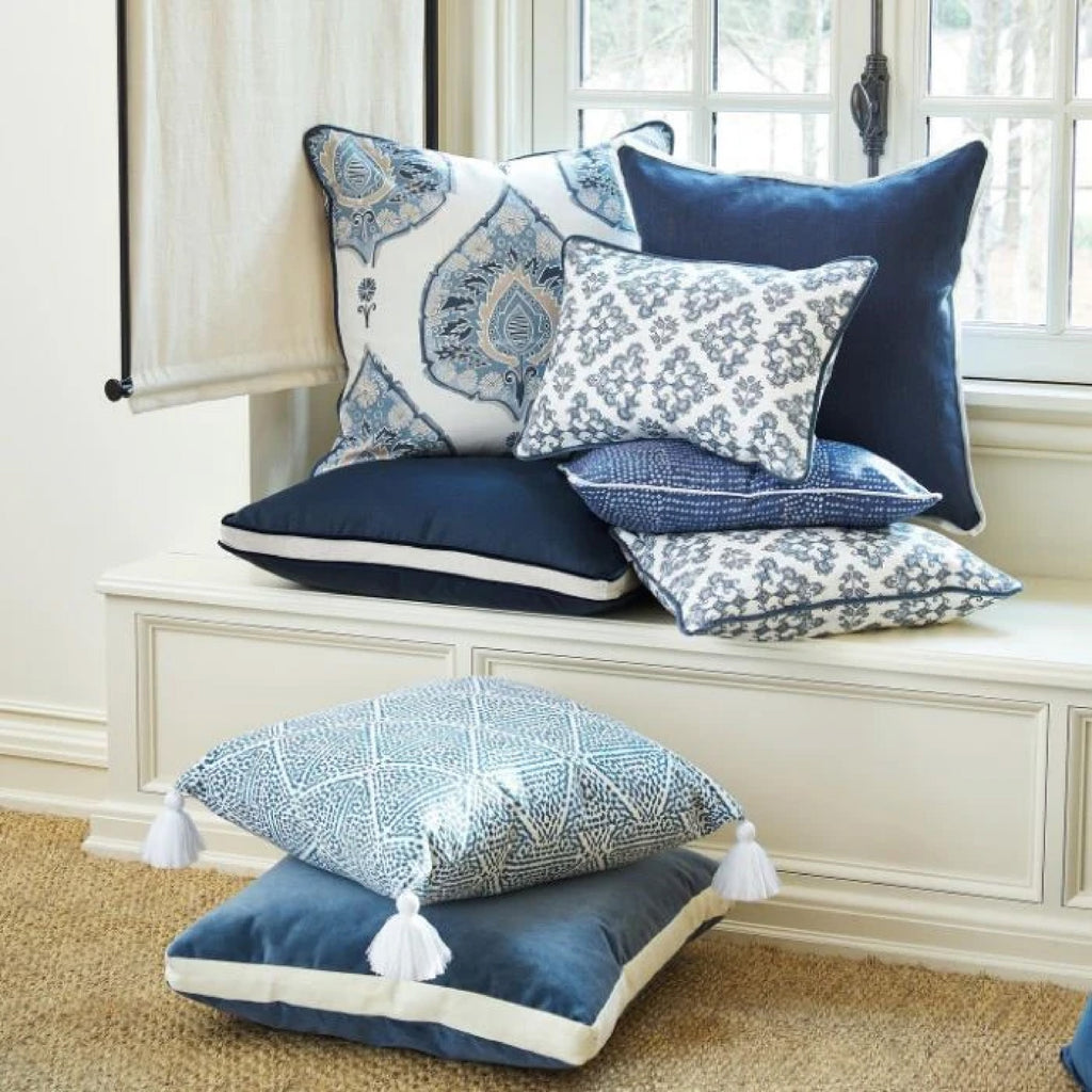 Stack of decorative throw pillows in an array of solid and pattern blues