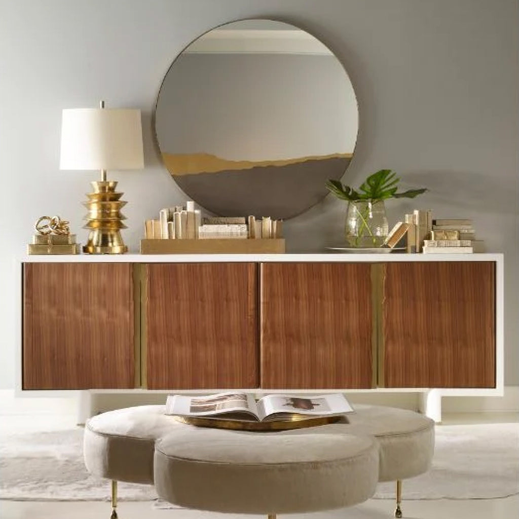 Round mirror over a white and wood console table