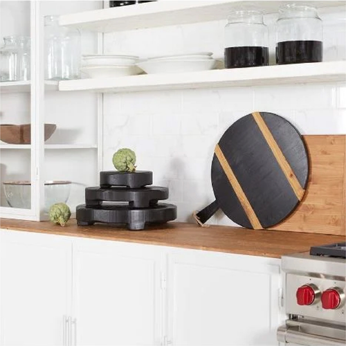 kitchen counter scene with wooden cutting boards and glassware