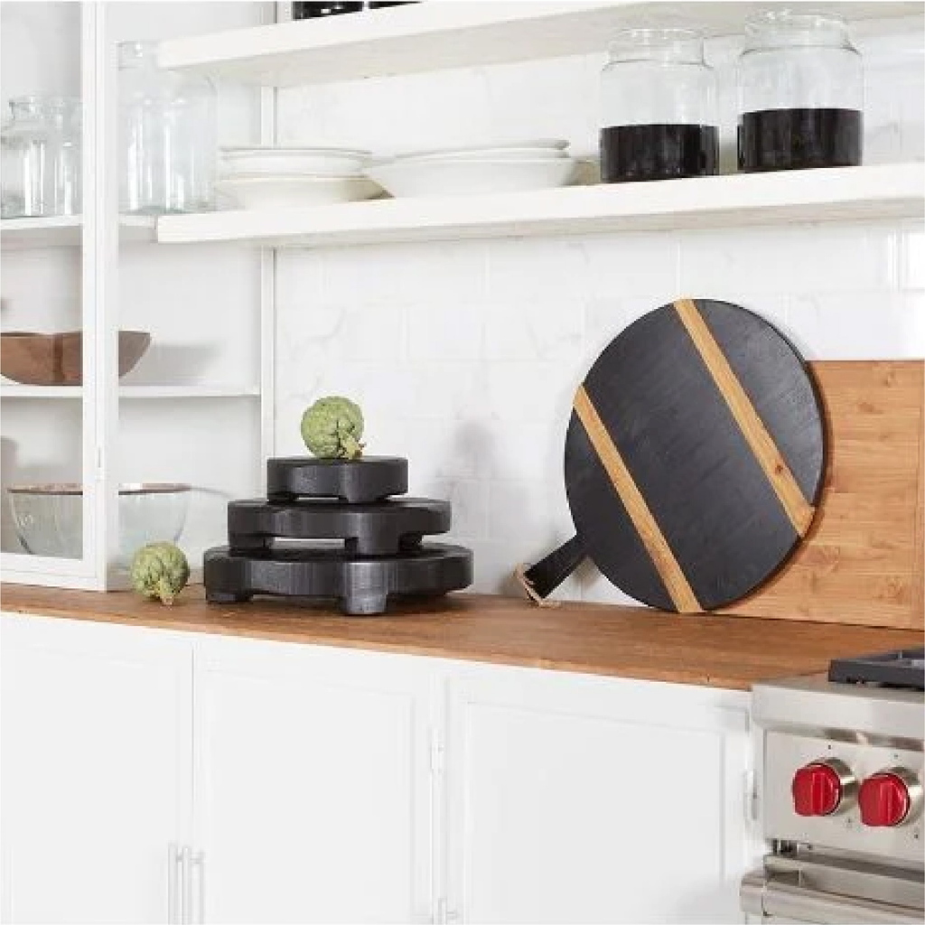 kitchen counter scene with wooden cutting boards and glassware
