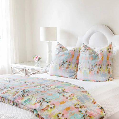 vibrant pink blue duvet cover and pillows on white bed