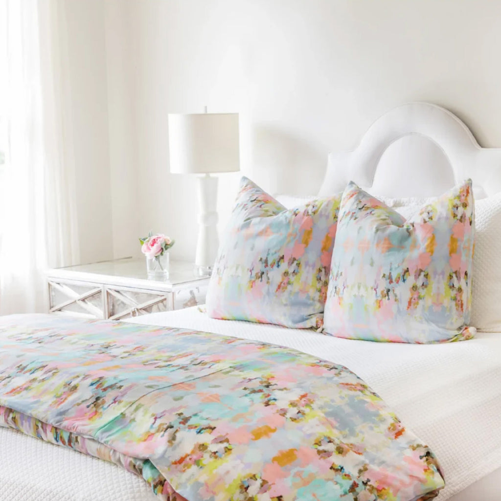 vibrant pink blue duvet cover and pillows on white bed