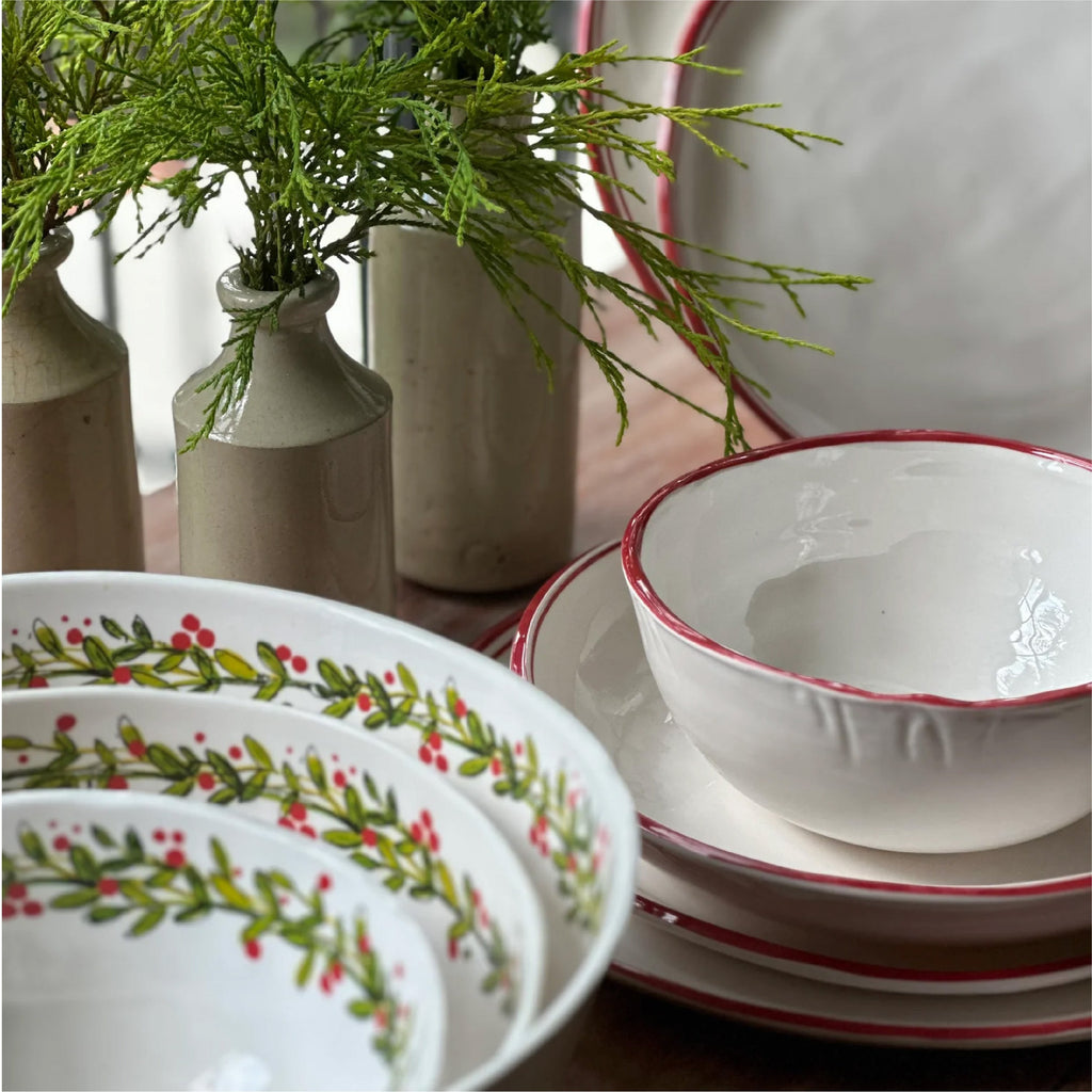 Set of holiday melamine dinnerware in white with a circular holiday pattern