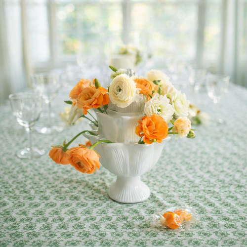 Artichoke Ivory Tulipiere with flowers in various shade of orange