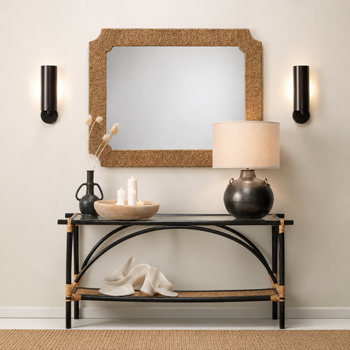 Black console table with decor, Jamie Young Two Handled Kettle Table Lamp, and candles under mirror and wall sconces.