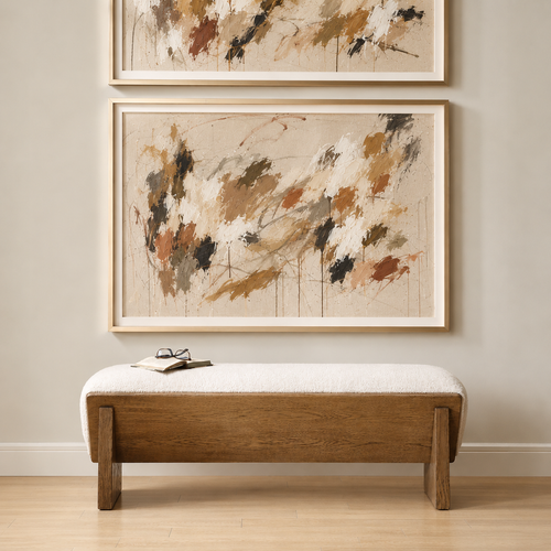 Wooden sideboard with decor, gold lamp, books, and round sunburst mirror on a beige wall.