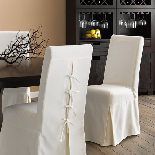 White dining chairs with bow detail down the back