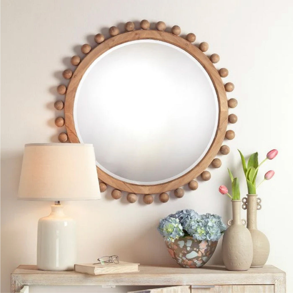 retangular shell framed mirror hanging above neutral console table