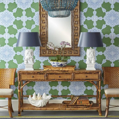 bamboo console table with lamps, decor and a wooden mirror