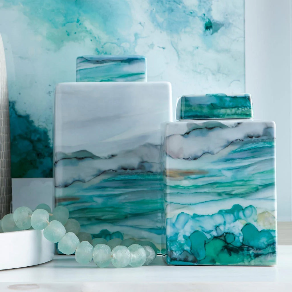 Two porcelain containers with a fluid water color effect of varying hues of greys and blues