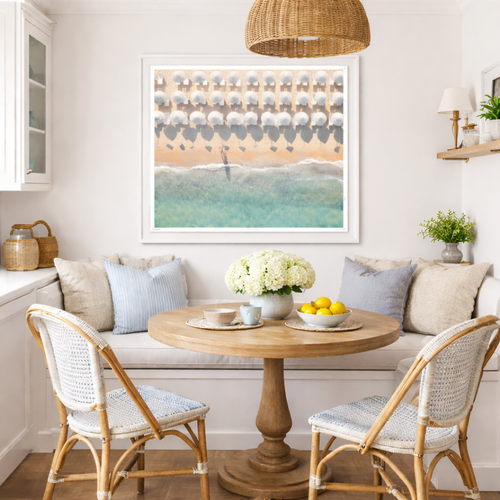 Hallway with beige walls, framed art, a small table with a lamp on the left, and a patterned rug on the floor.
