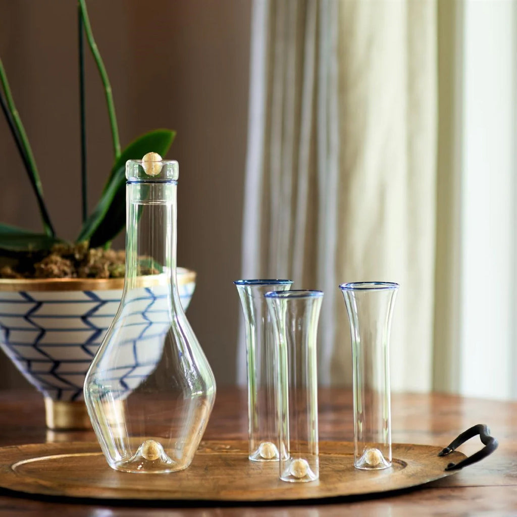 clear carafe and blue rimmed glasses 