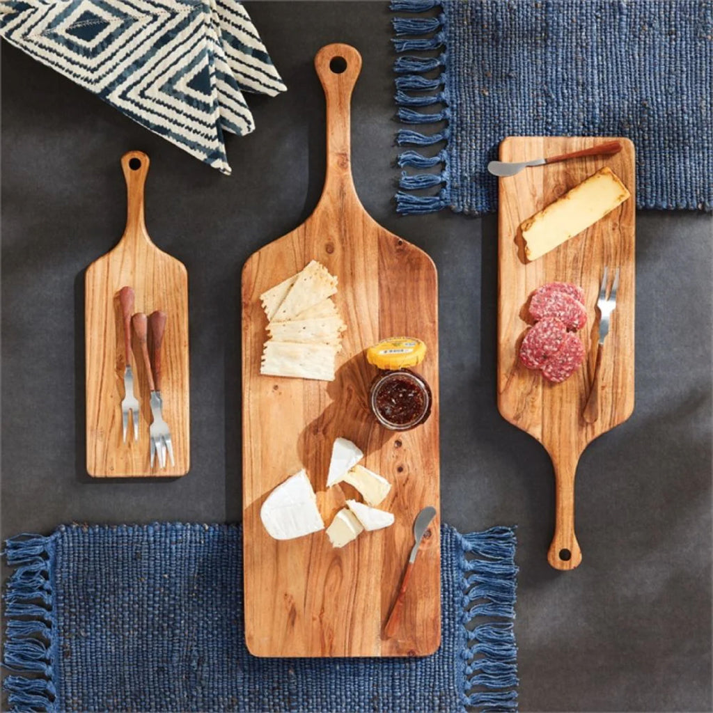 3 different size wooden cutting boards with cheeses and meats
