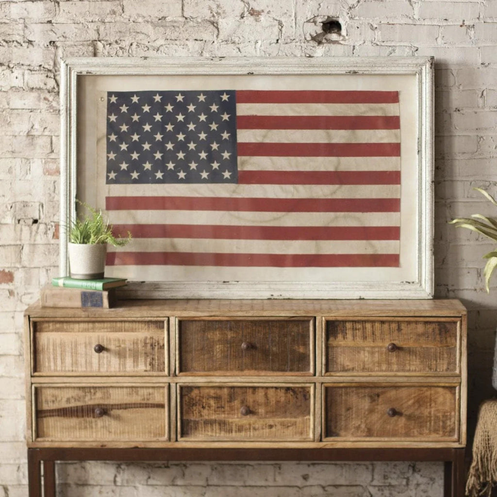 american flag art and wooden console 