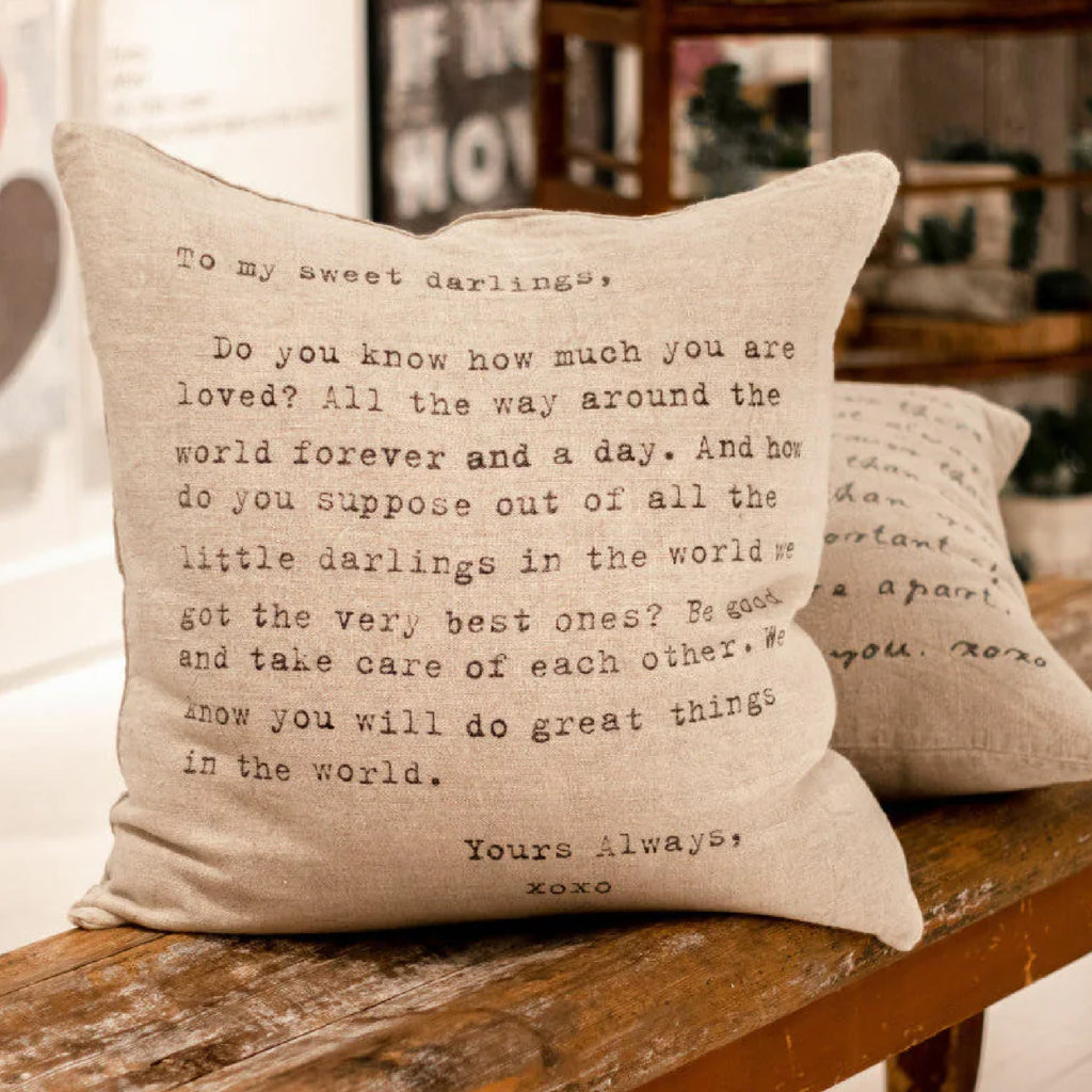 Sugarboo Message Pillow sitting on a wooden bench