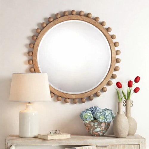 retangular shell framed mirror hanging above neutral console table