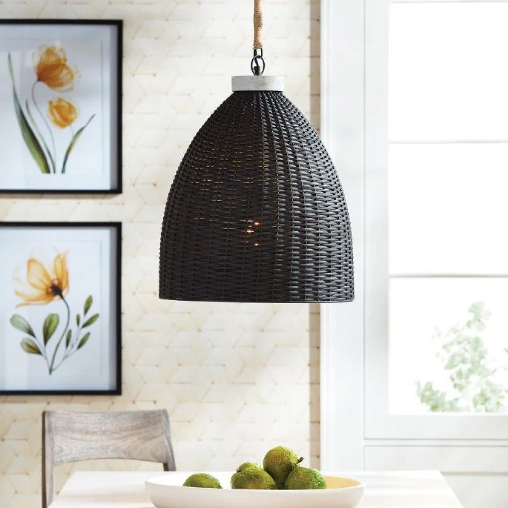 Bronze candle lantern in the shape of a steeple sittng on a black console