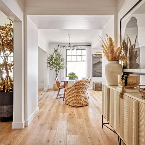 coastal foyer with wood console and seagrass chair