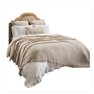 beige throw on white bedding collection of duvet and pillows