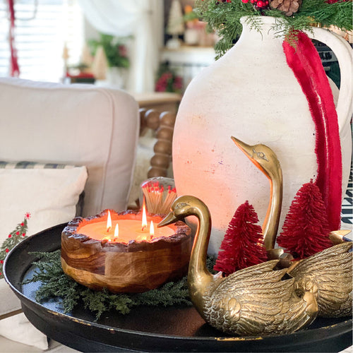 Lit endurance candle on tray with decor
