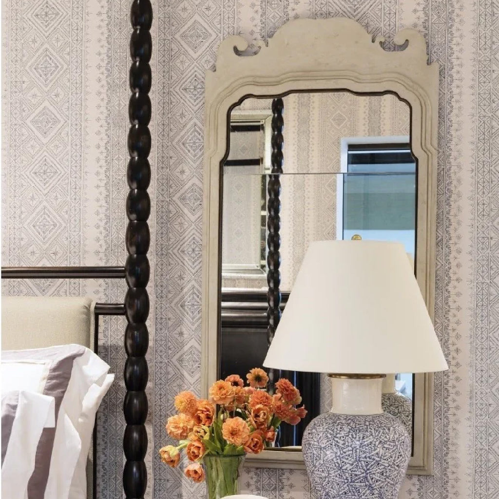 White mirror above nightstand with lamp and decor from Mirror Home