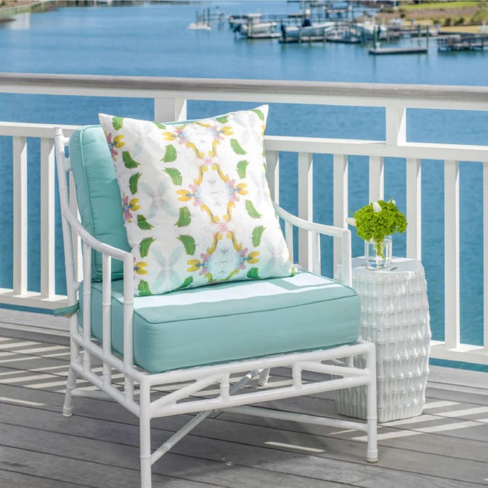 white and green pattern pillow on a white and blue outdoor chair