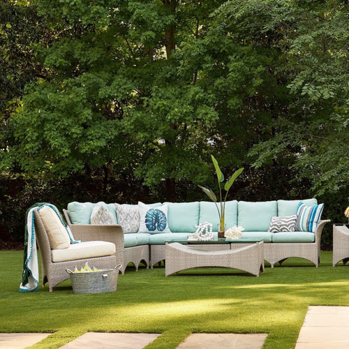 outdoor seating area with aqua cushion rattan sofa and chair