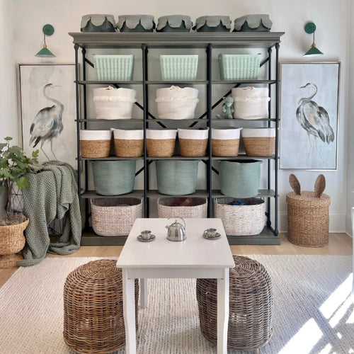 large wall shelf filled with pretty bins and baskets for organization in playrooms