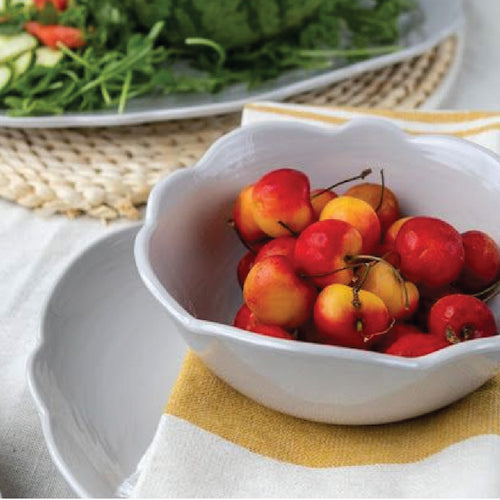 light gray melamine dish and bowl on table with seagrass placemat and white napkin