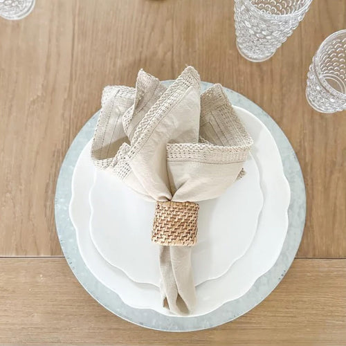 neutral melamine place setting with a napkin on a lightwood desk