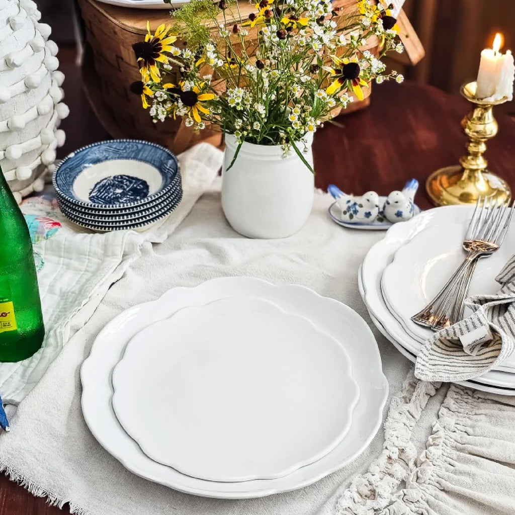 white scalloped edge melamine dinnerware set on a table