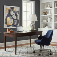 Modern home office with dark wooden desk, blue swivel chair, and The Natural Light's Forest Green Canopy Table Lamp.