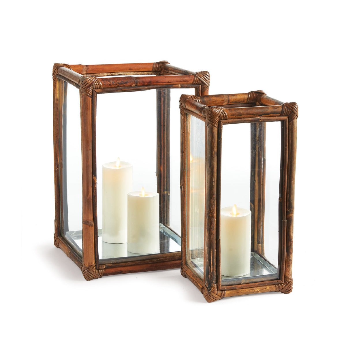 Two wooden lanterns with glass panels containing candles on a white background